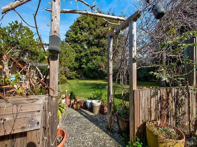 a living room with furniture a window and a book shelf