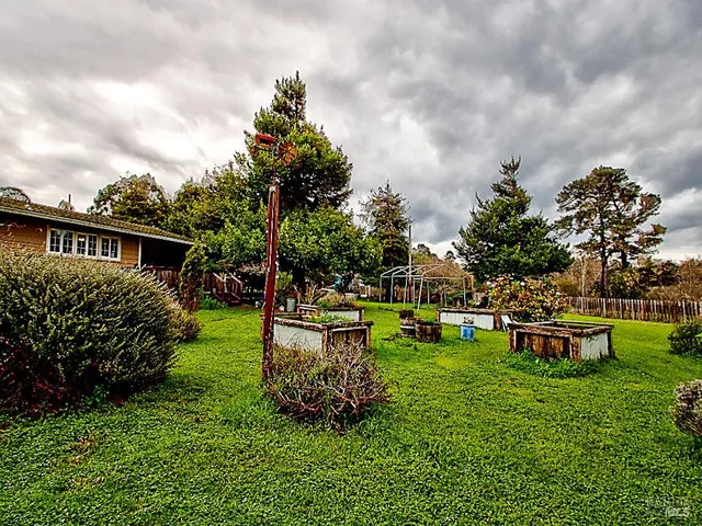 a view of a house with backyard sitting area and garden