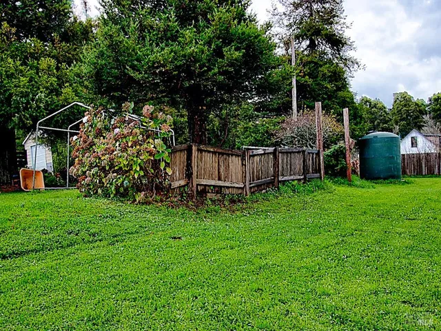 a view of a chair and table in the garden