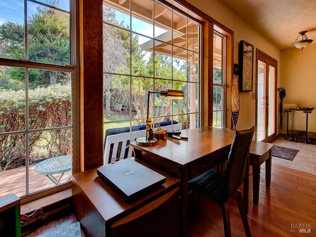 a view of a dining room with furniture and chandelier