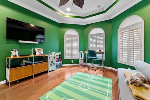 an aerial view of a house with garden space and street view