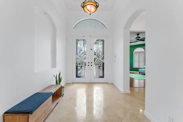a view of a dining room with furniture a chandelier and wooden floor
