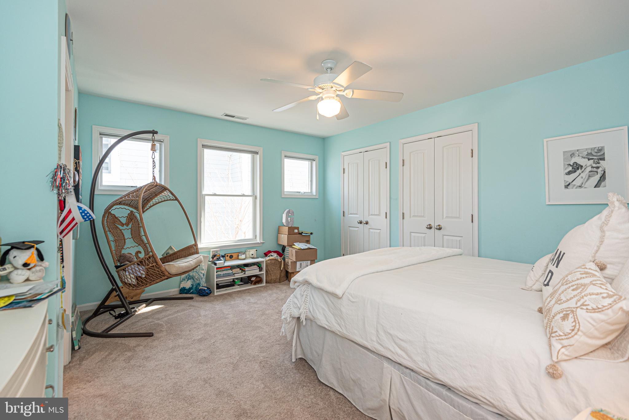 1502 Bay Street Fenwick Island, DE 19944 - Photo 44 of 62 a bedroom with a bed a chandelier and a dresser