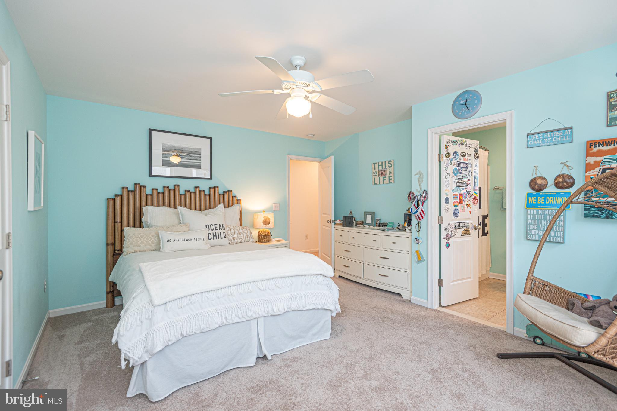 1502 Bay Street Fenwick Island, DE 19944 - Photo 45 of 62 a spacious bedroom with a bed and a chandelier