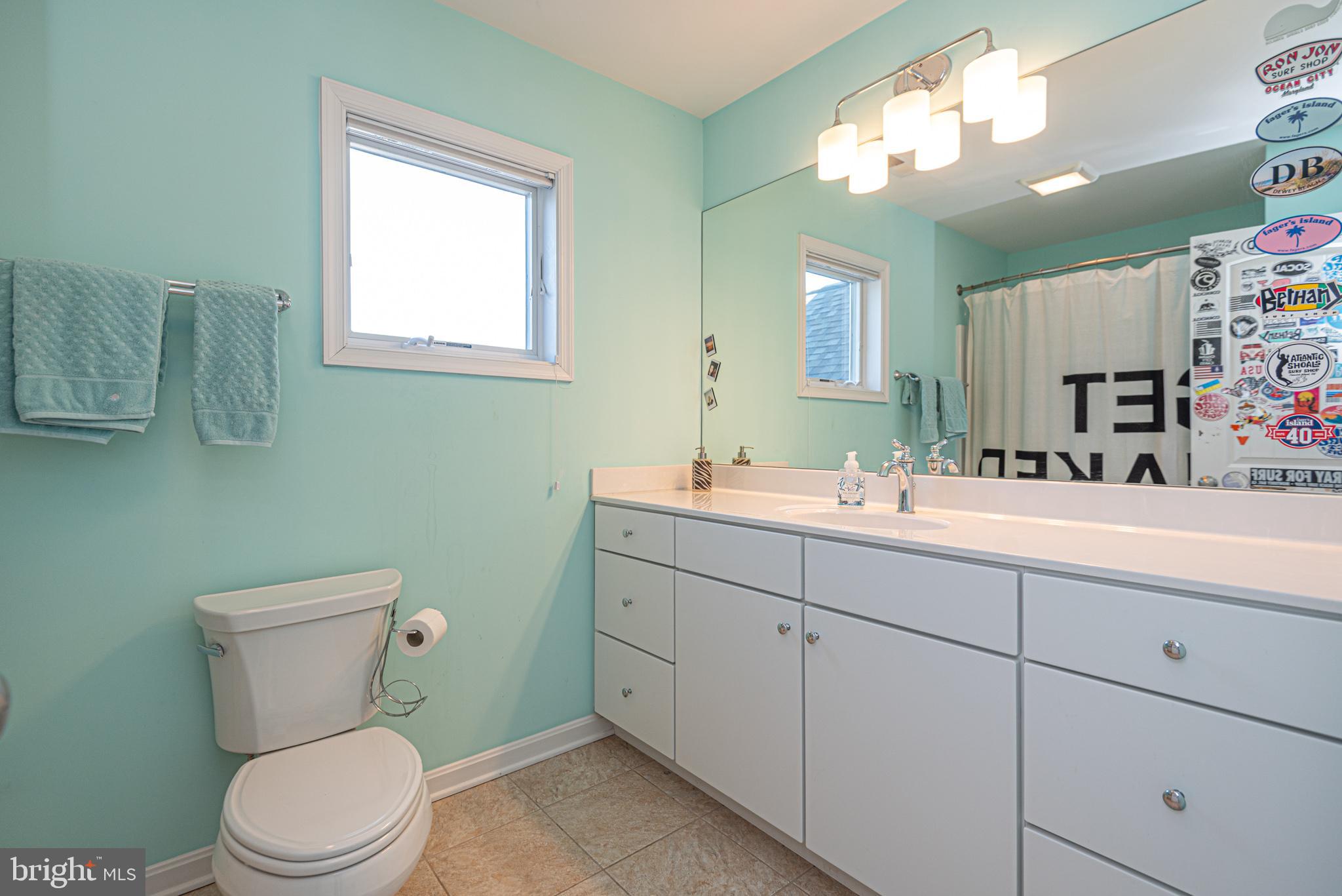 1502 Bay Street Fenwick Island, DE 19944 - Photo 46 of 62 a bathroom with a toilet sink and mirror