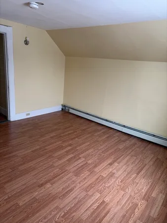 a view of an empty room and wooden floor