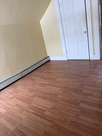 a view of room with wooden floor