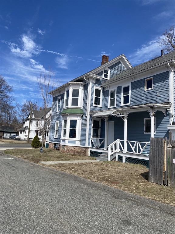 111 Bay, Unit 113 Springfield, MA 01109 - Photo 2 of 13 a front view of a house with a yard