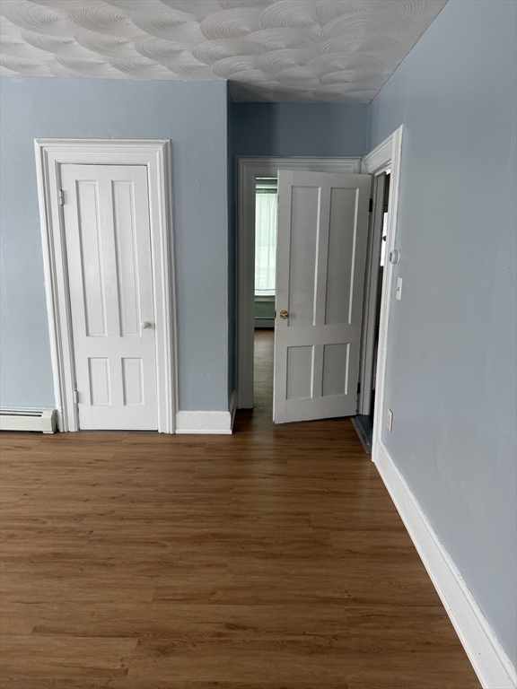 111 Bay, Unit 113 Springfield, MA 01109 - Photo 6 of 13 a view of an empty room with wooden floor and a window