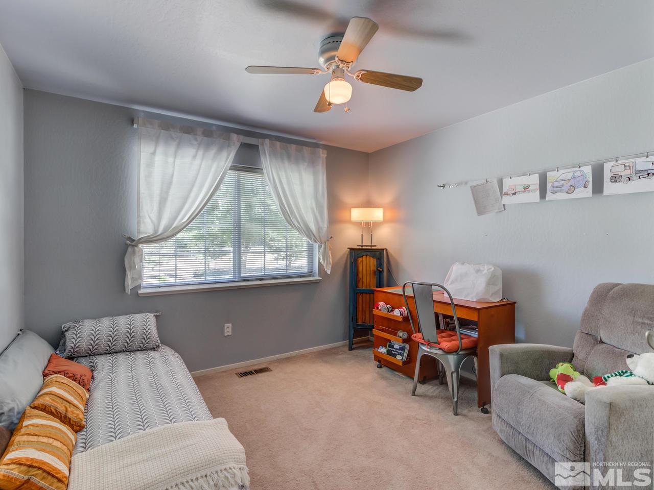 10570 Trailmaster Drive Reno, NV 89508 - Photo 13 of 25 a bedroom with furniture and a large window