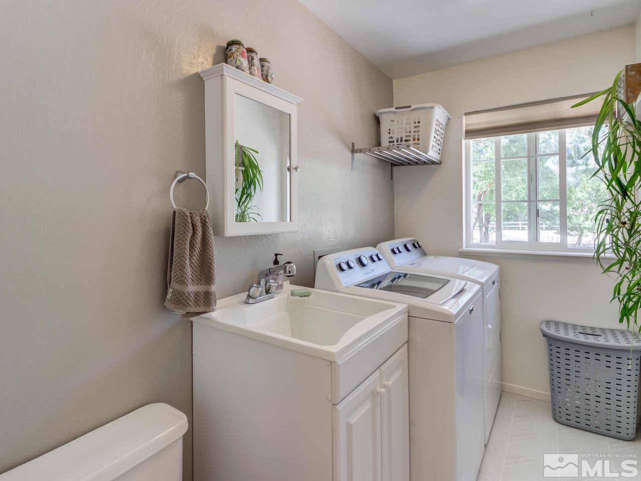 10570 Trailmaster Drive Reno, NV 89508 - Photo 17 of 25 a utility room with sink dryer and washer