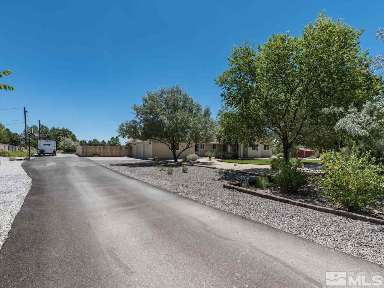 10570 Trailmaster Drive Reno, NV 89508 - Photo 24 of 25 a backyard of a house with a yard and outdoor seating