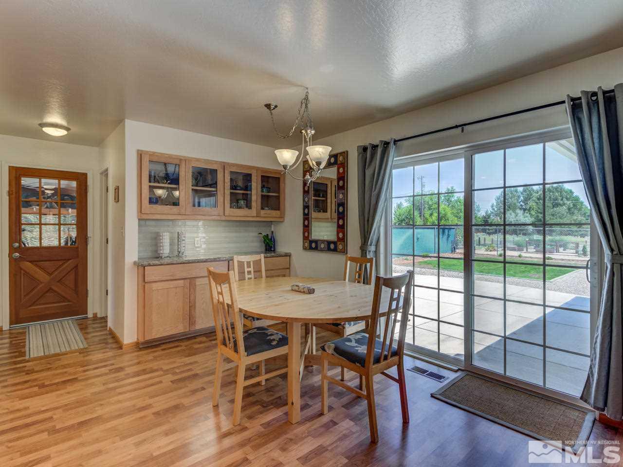 10570 Trailmaster Drive Reno, NV 89508 - Photo 7 of 25 a view of a dining room with furniture window and wooden floor