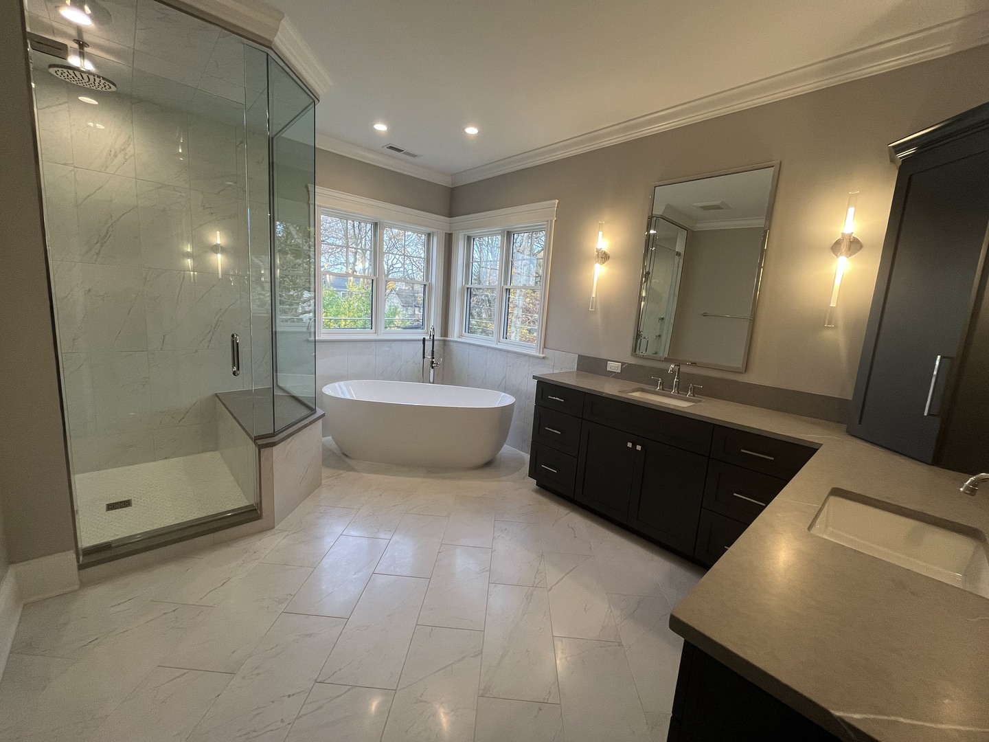 928 Hunter Road Glenview, IL 60025 - Photo 13 of 24 a spacious bathroom with a double vanity sink a large mirror and shower