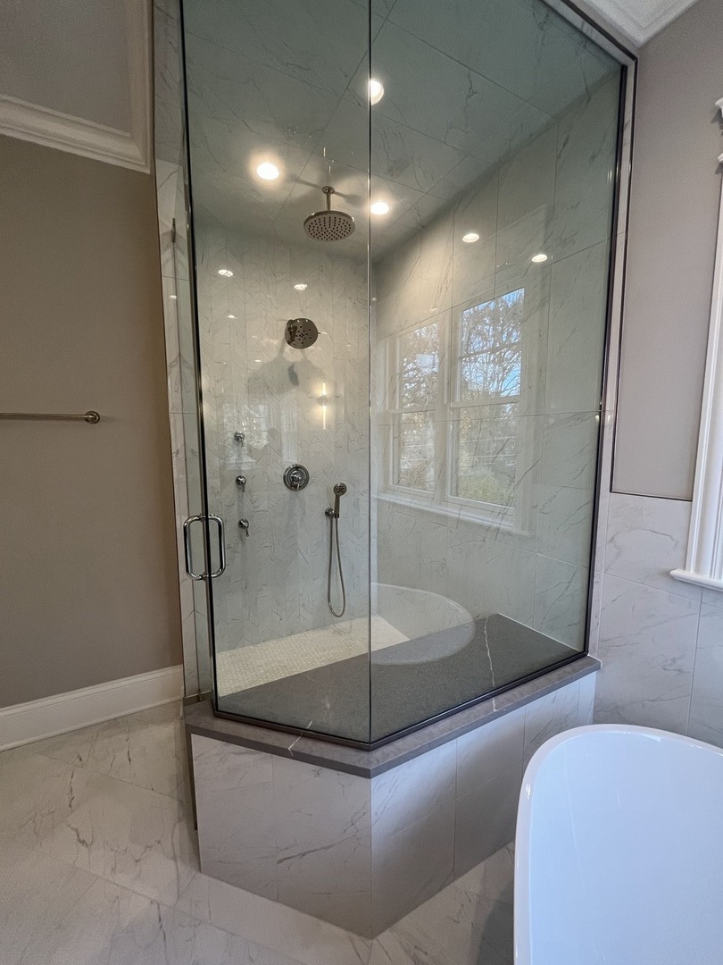 928 Hunter Road Glenview, IL 60025 - Photo 14 of 24 a bathroom with a tub and shower