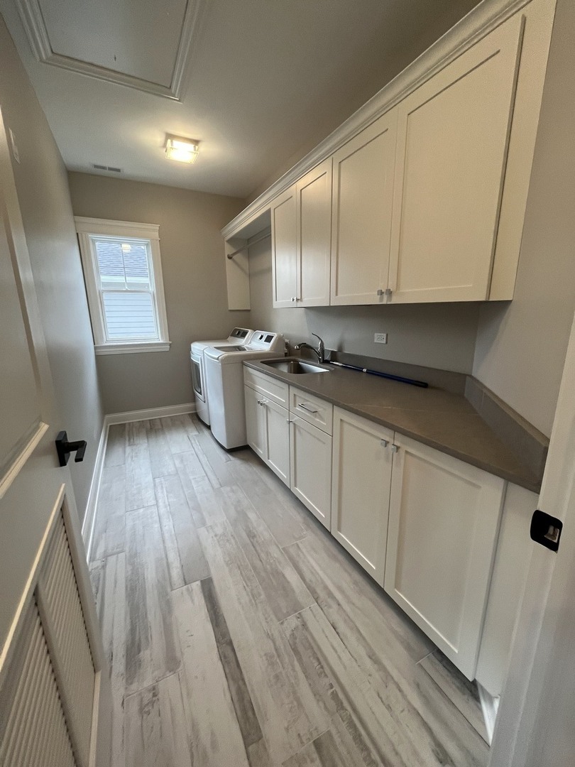 928 Hunter Road Glenview, IL 60025 - Photo 19 of 24 a kitchen with a sink wooden floor and white stainless steel appliances