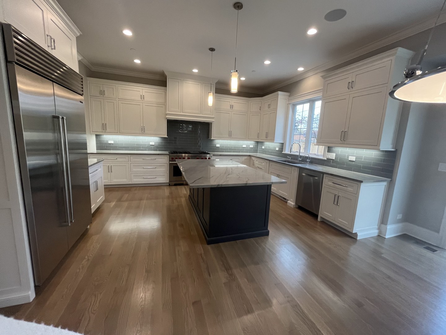 928 Hunter Road Glenview, IL 60025 - Photo 5 of 24 a kitchen with stainless steel appliances granite countertop a sink a stove and refrigerator