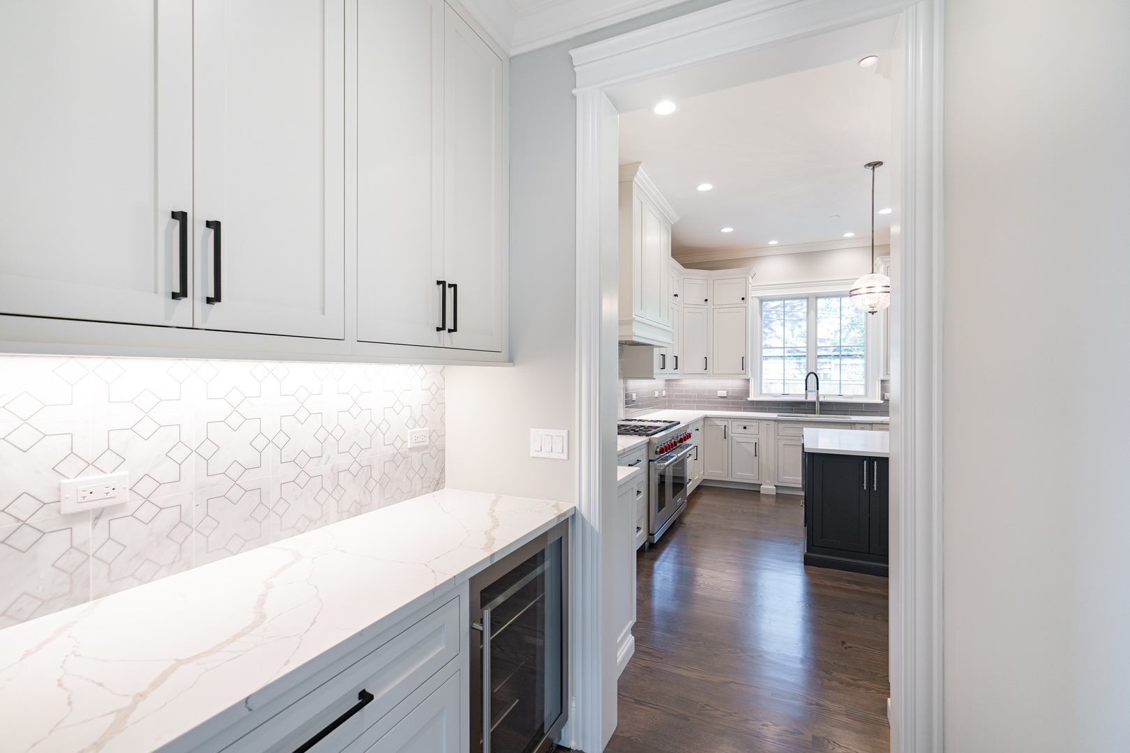 928 Hunter Road Glenview, IL 60025 - Photo 8 of 24 a open kitchen with white cabinets and wooden floor