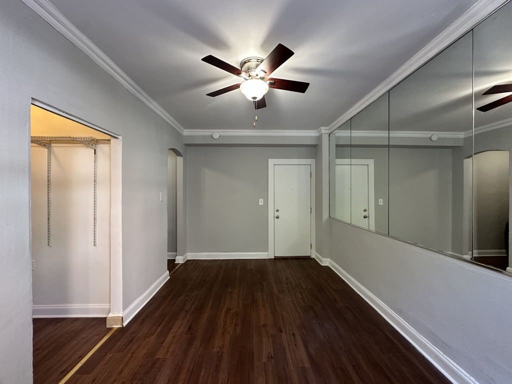 661 West Sheridan Road, Unit 208 Chicago, IL 60613 - Photo 12 of 20 a view of empty room with wooden floor and fan