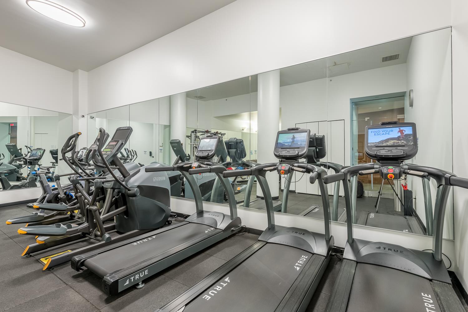 46-30 Center Boulevard, Unit 401 Queens, NY 11109 - Photo 13 of 18 a view of a room with gym equipment