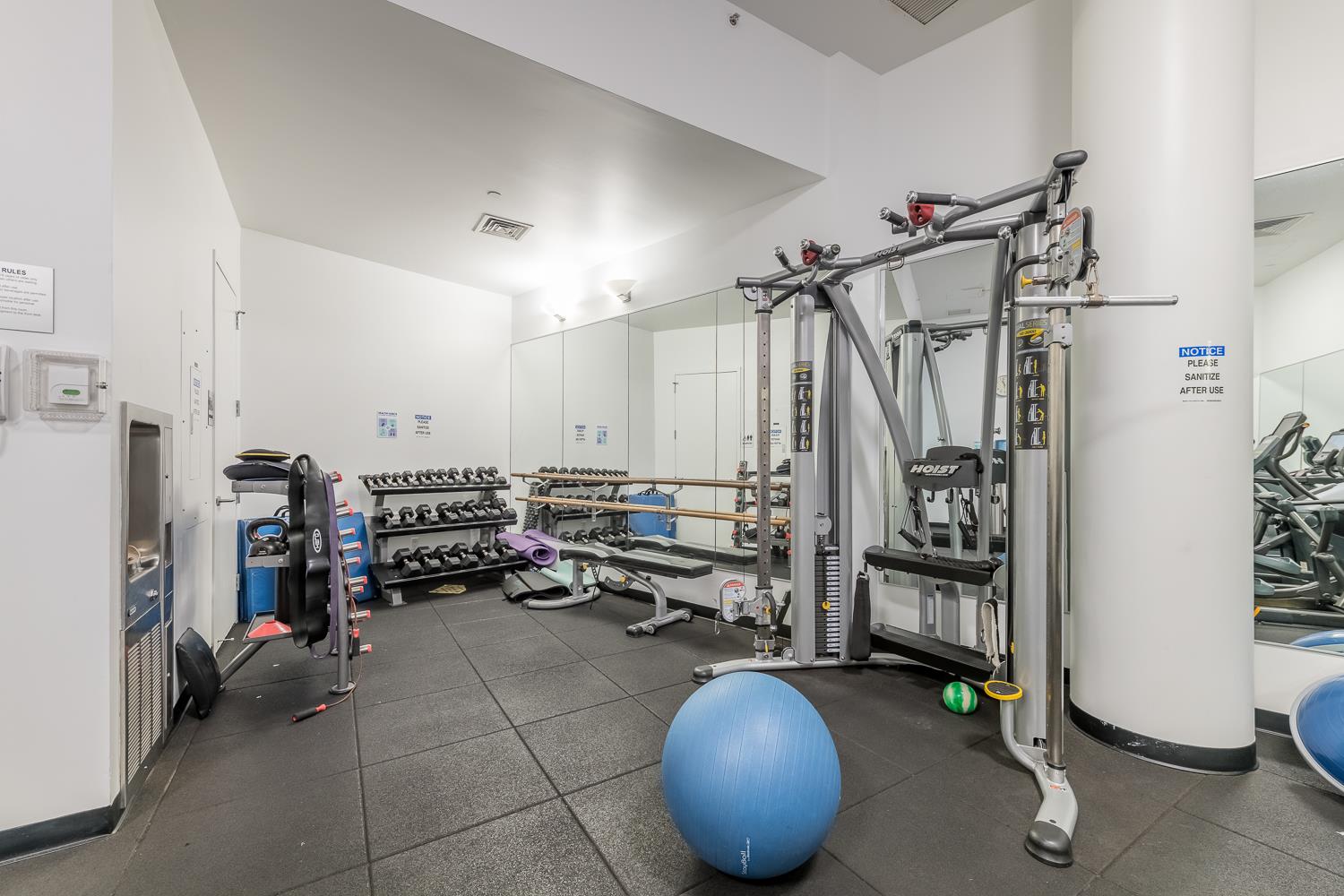 46-30 Center Boulevard, Unit 401 Queens, NY 11109 - Photo 14 of 18 a room with lots of furniture and a chandelier