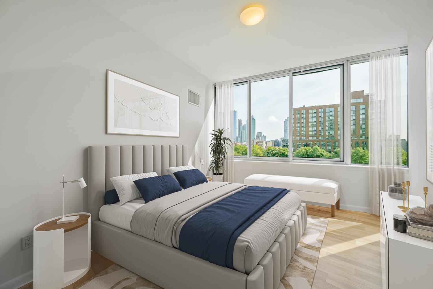 46-30 Center Boulevard, Unit 401 Queens, NY 11109 - Photo 5 of 18 a bedroom with a bed and a large window