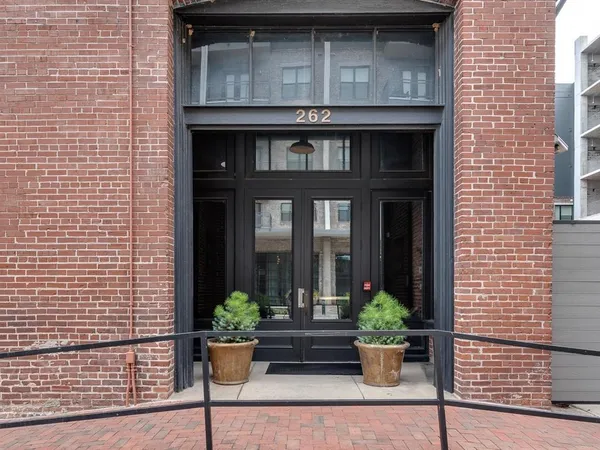 a view of a house door with potted plants