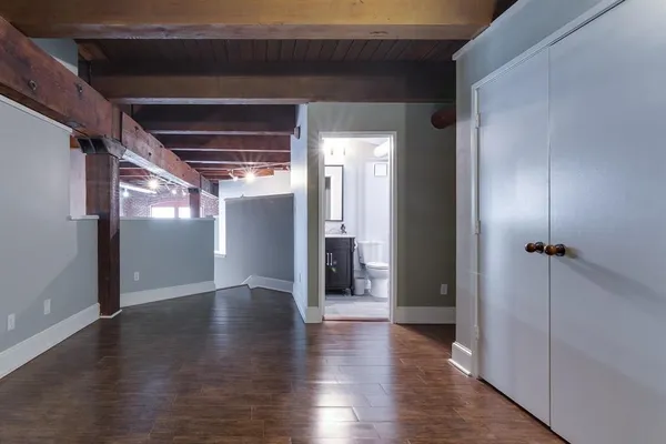 a view of a hallway with wooden floor