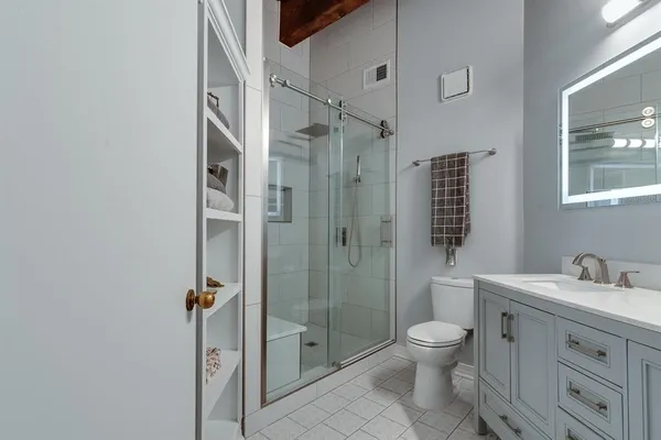 a bathroom with a toilet a sink and shower
