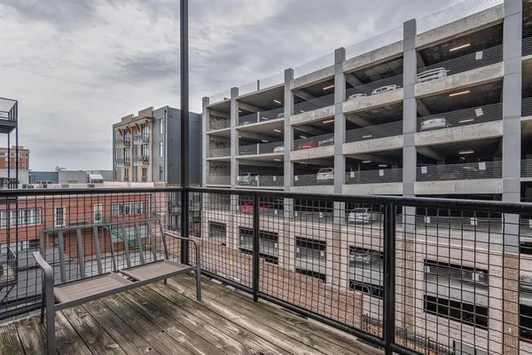 a view of front door with balcony and wooden floor