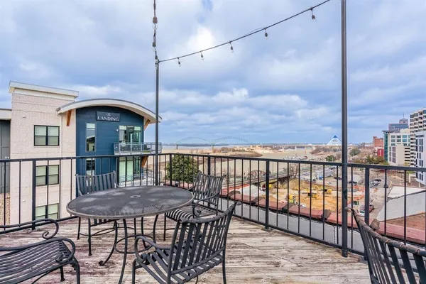 a view of a balcony with a table and chairs