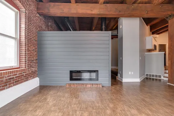 a view of outdoor space with wooden floor and a fireplace
