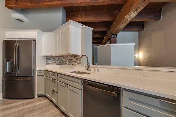 a kitchen with a sink and refrigerator