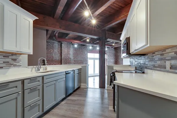 a kitchen with a sink appliances and cabinets