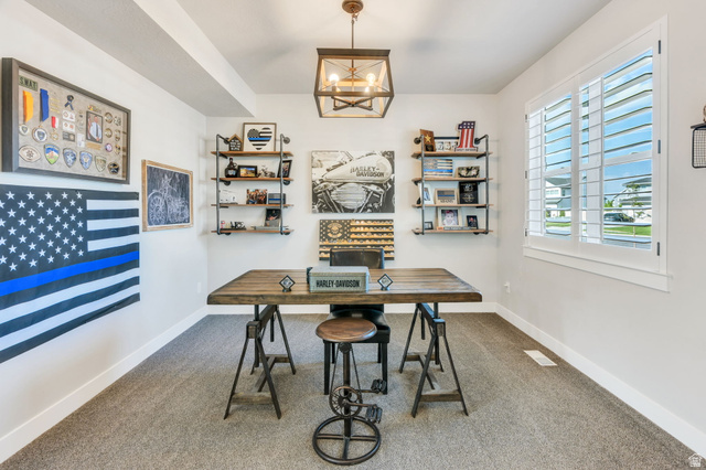 252 North Sunrise Rnch Drive Mapleton, UT 84664 - Photo 11 of 62 Versatile room featuring light neutral wall paint, gray carpeting, a large window with white plantation shutters, and a central ceiling light fixture