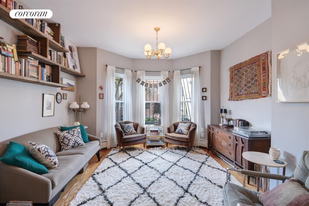 36 Pilling Street Brooklyn, NY 11207 - Photo 1 of 1 a living room with furniture a chandelier and a dining table