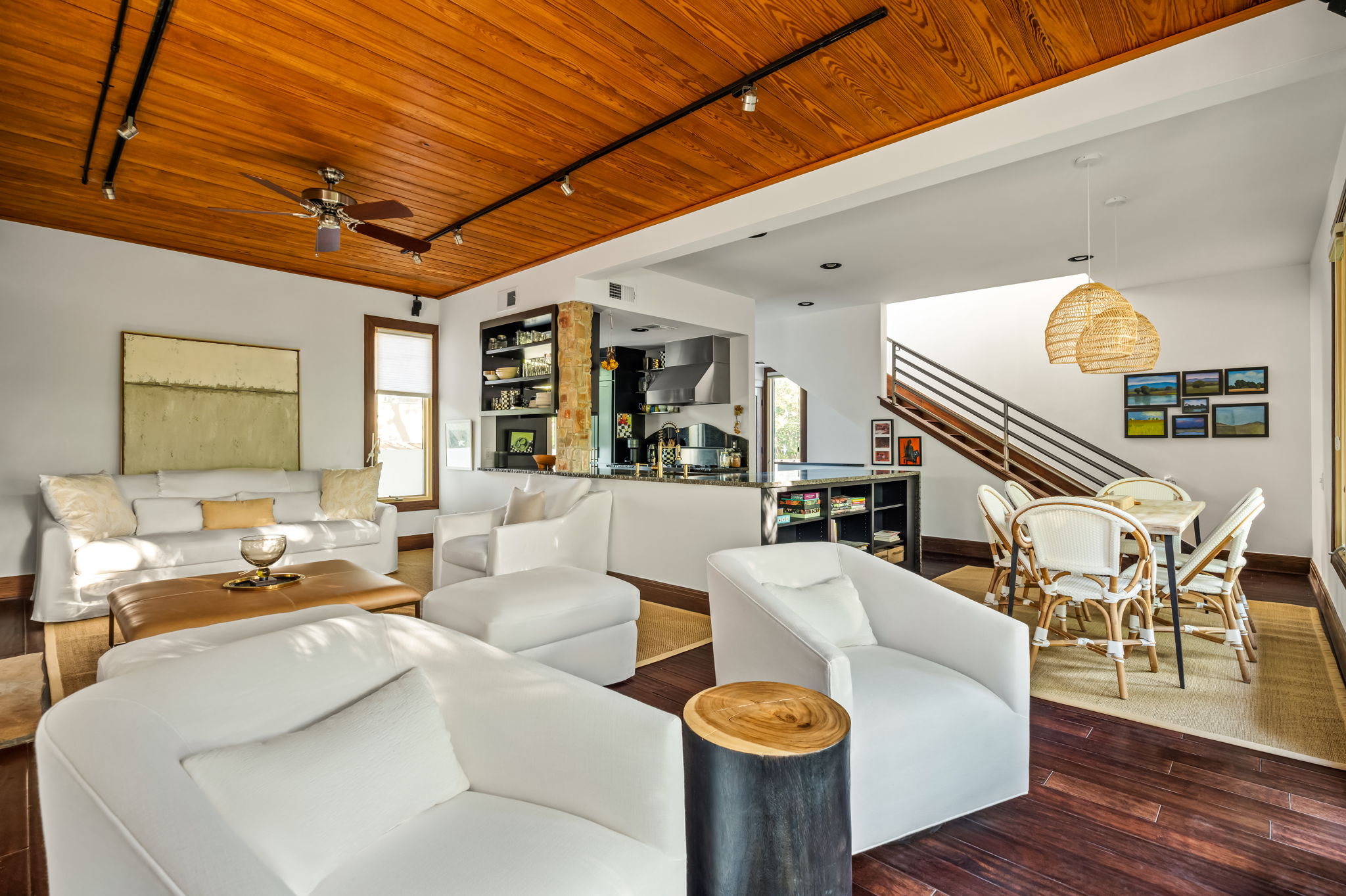 1111 West 12th Street, Unit 107 Austin, TX 78703 - Photo 22 of 38 Open-concept living area featuring rich wood-finish flooring, a wood plank ceiling, and a modern staircase with a metal railing