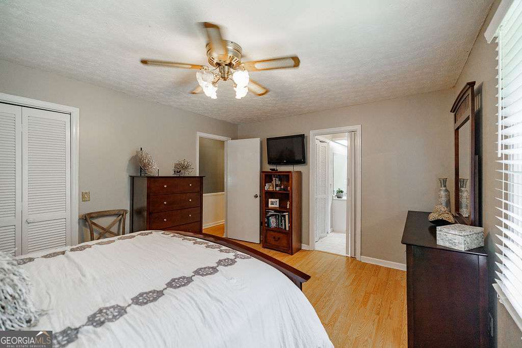 226 Baker Street Statham, GA 30666 - Photo 13 of 63 a bedroom with a bed and a chandelier