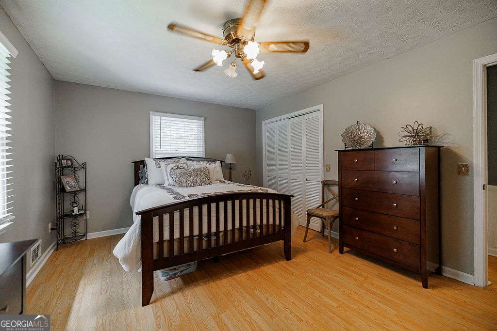 226 Baker Street Statham, GA 30666 - Photo 14 of 63 a bedroom with a bed and a dresser