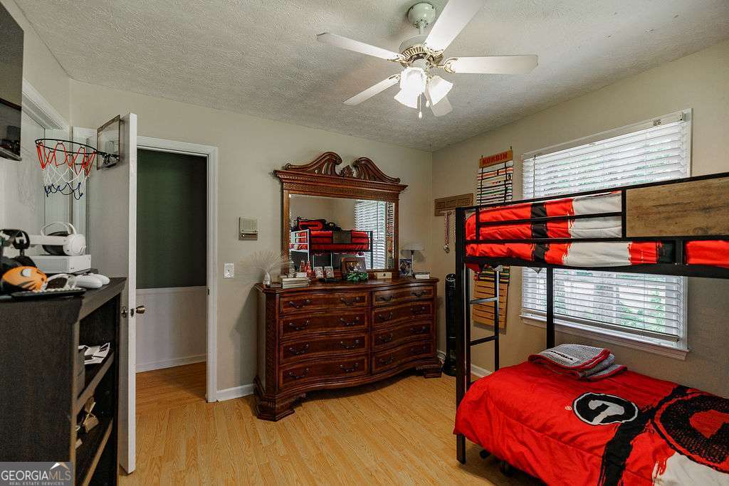 226 Baker Street Statham, GA 30666 - Photo 18 of 63 a bedroom with a bed and wooden floor