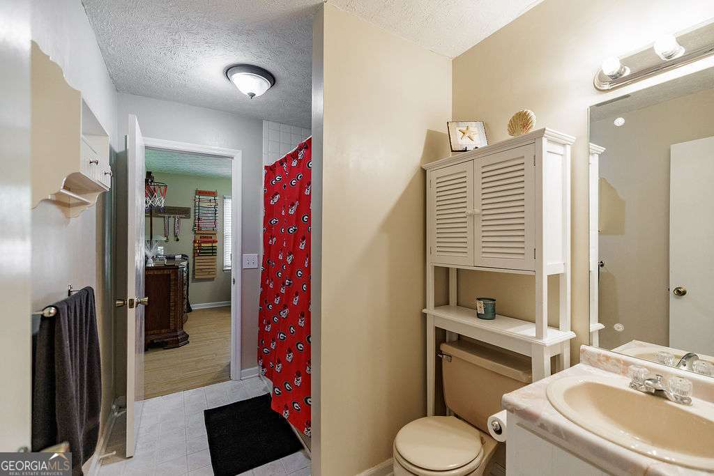 226 Baker Street Statham, GA 30666 - Photo 19 of 63 a bathroom with a sink toilet and shower