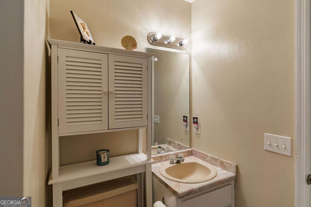 226 Baker Street Statham, GA 30666 - Photo 20 of 63 a bathroom with a sink a toilet and mirror