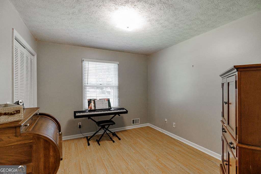 226 Baker Street Statham, GA 30666 - Photo 21 of 63 a view of a workspace with furniture and a window