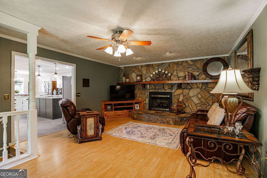 226 Baker Street Statham, GA 30666 - Photo 25 of 63 a living room with furniture a fireplace and a flat screen tv