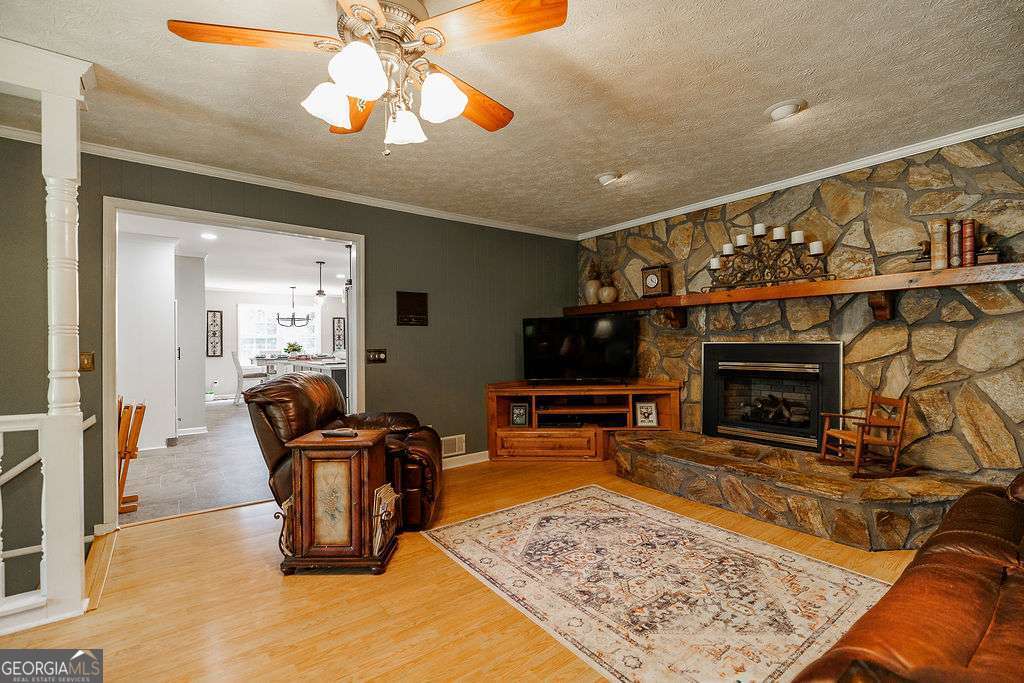 226 Baker Street Statham, GA 30666 - Photo 27 of 63 a living room with fireplace furniture and a flat screen tv