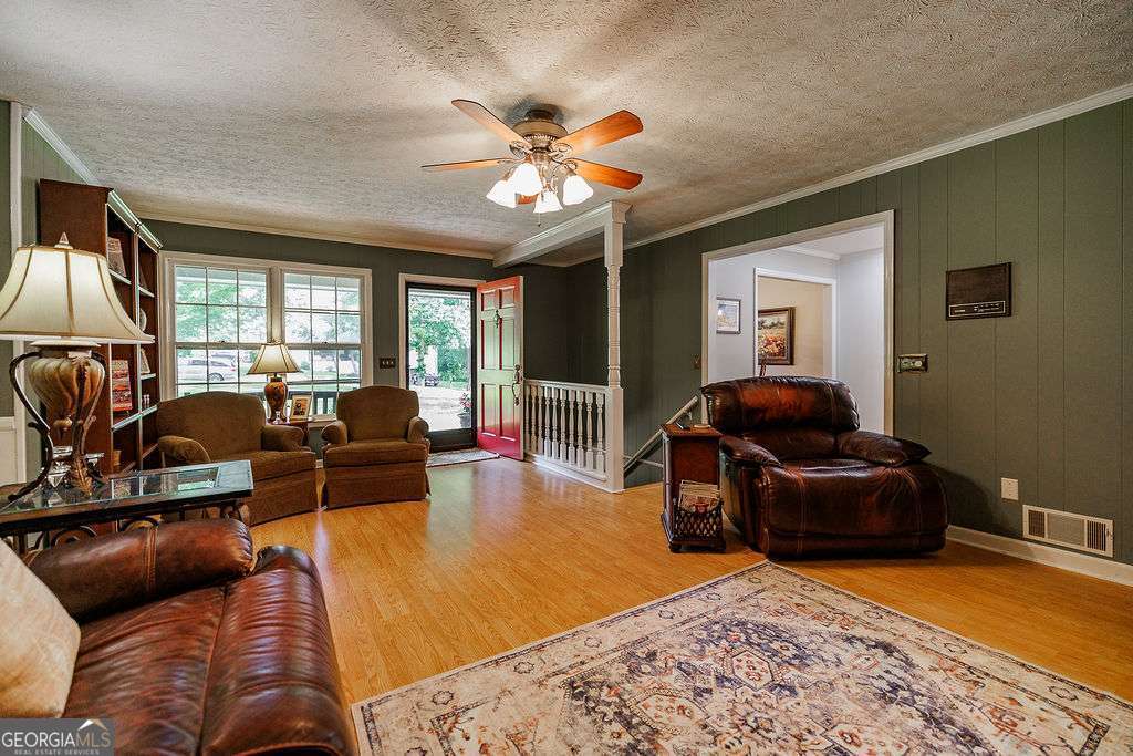226 Baker Street Statham, GA 30666 - Photo 28 of 63 a living room with furniture and a flat screen tv