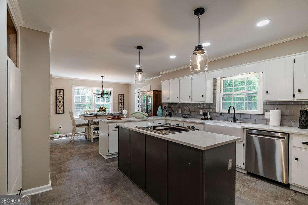 226 Baker Street Statham, GA 30666 - Photo 29 of 63 a kitchen with a stove a sink a refrigerator a center island and a window