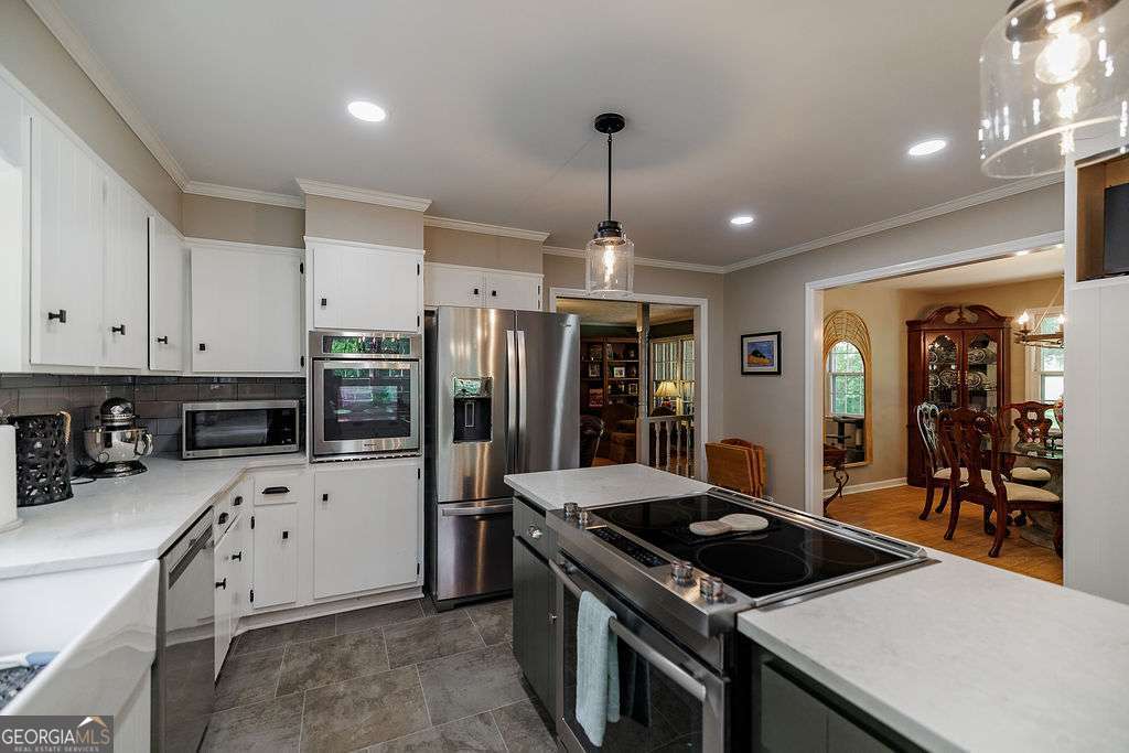 226 Baker Street Statham, GA 30666 - Photo 30 of 63 a kitchen with granite countertop a sink appliances and cabinets