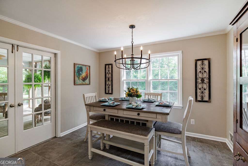 226 Baker Street Statham, GA 30666 - Photo 33 of 63 a dining room with furniture a chandelier and wooden floor