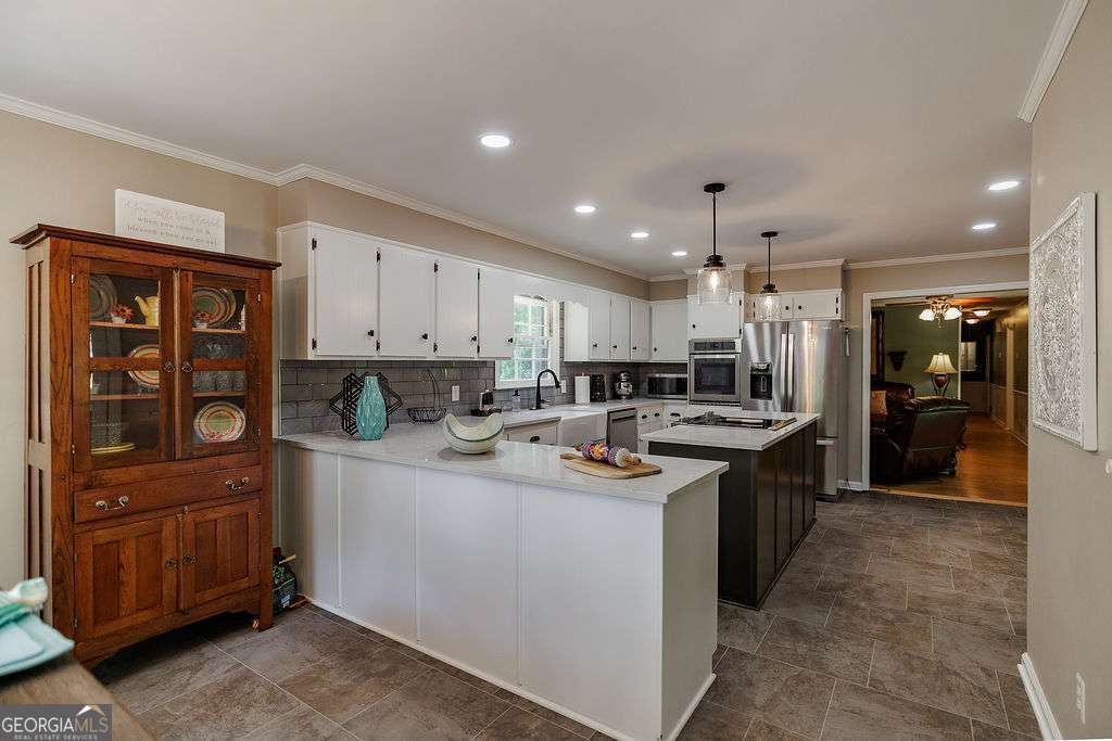 226 Baker Street Statham, GA 30666 - Photo 34 of 63 a kitchen with stainless steel appliances granite countertop a sink stove and refrigerator